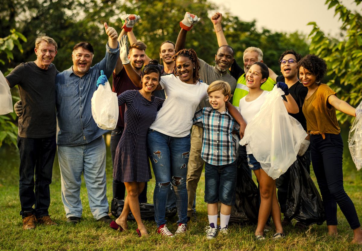A cheering group of neighbors of all ages after a community volunteer day